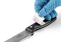 The white lifter is removed from the knife showing the lifted stain.