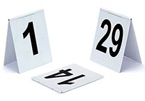 Number signs (several number ranges available), tent design, with hinge on the top. White with black printing. Dimensions: 9 x 11 cm.